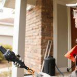 Exterminator inspecting home for termite damage.